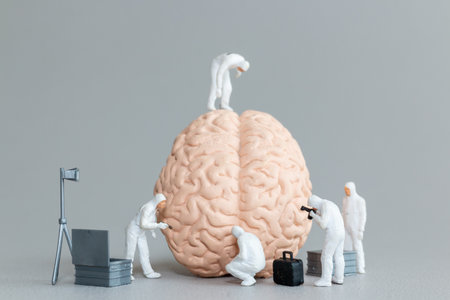 Miniature figures in hazmat suits inspect and analyze a giant brain model
