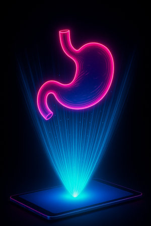 Holographic projection of a human stomach glowing above a digital tablet on dark background.の素材