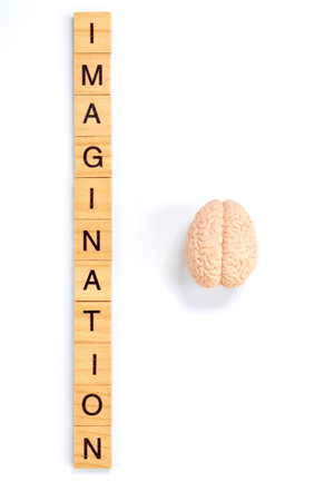 Wooden letter tiles spelling Imagination on white background, symbolizing creativity, innovation, and the power of ideas.の写真素材
