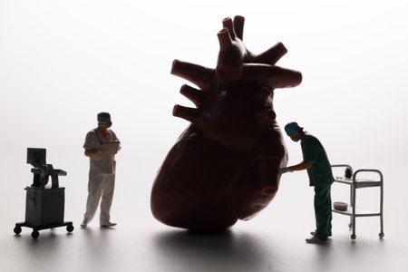 Conceptual image of miniature surgeons performing heart surgery on an anatomical heart model,...