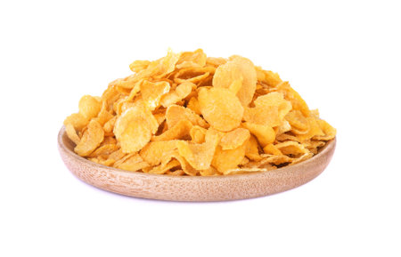 cereal corn flakes in wooden dish isolated on white backgroundの写真素材