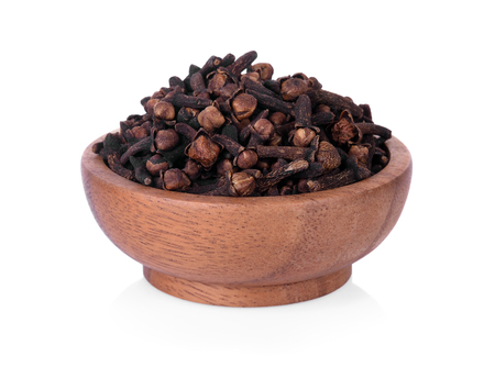 spicy dried clove, syzygium aromaticum flower buds in wooden bowlの写真素材