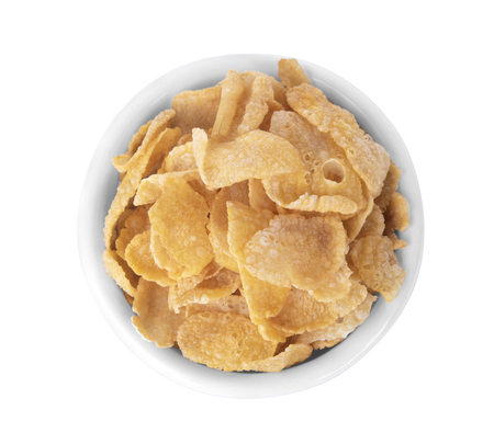 Breakfast cereal cornflakes in white ceramic bowl isolated on white background.の写真素材