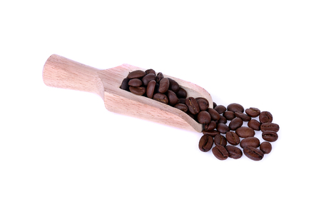 Coffee beans and wooden scoop isolate on white backgroundの写真素材