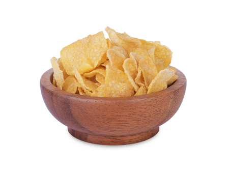 Breakfast cereal cornflakes in wooden bowl isolated on white background.の写真素材