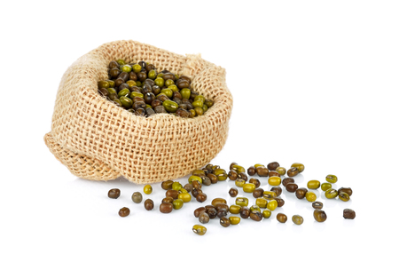 Mung beans (Vigna radiata) in bag on white backgroundの写真素材