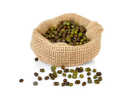 Mung beans (Vigna radiata) in bag on white backgroundの写真素材