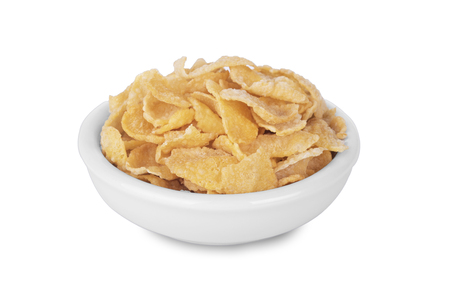 Breakfast cereal cornflakes in white ceramic bowl isolated on white background.の写真素材