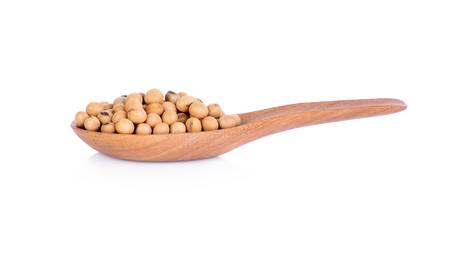 Soy beans in wooden spoon on white backgroundの写真素材