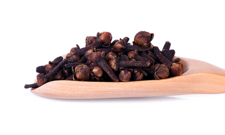 Close-up spicy dried clove, syzygium aromaticum flower buds in wooden spoonの写真素材