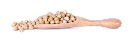 uncooked chickpeas in wooden spoon on white backgroundの写真素材