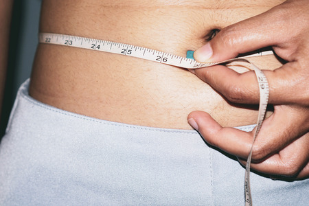 Woman measuring waistの写真素材
