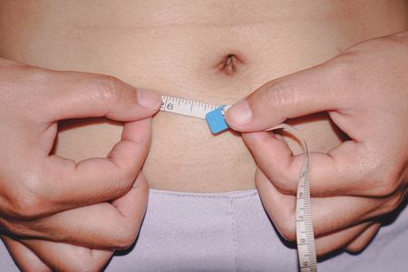 Woman measuring waistの写真素材