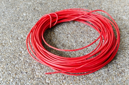Red hot power cable on sand floorの写真素材