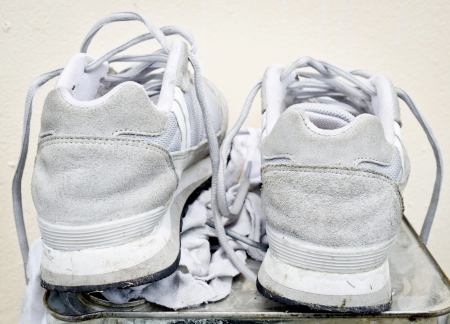 Old Running Shoes on mteal box with white ragの写真素材
