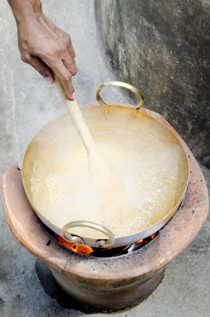 Hand make sugar syrup for thai dessert with brass panの写真素材