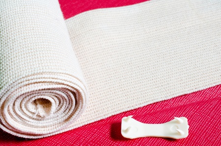 Roll of the elastic bandage against with Cherry color background   の写真素材