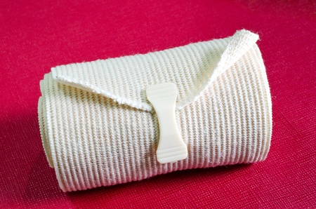 Roll of the elastic bandage against with Cherry color backgroundの写真素材