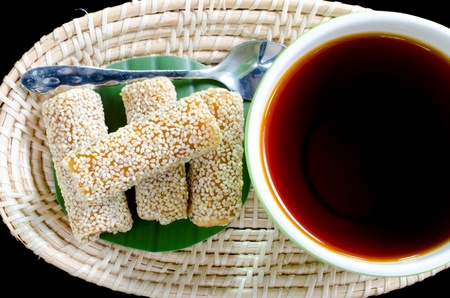 Cup of tea with Sesame Cookies on basket , black backgroundの写真素材