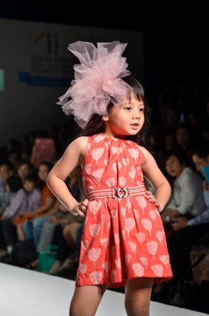 THAILAND, BANGKOK- OCT 2013 : A model walks the runway at the Ginger Snaps New Collection 2013 at Kids Internation Fashion Week 2013 during 5-6 october, 2013 in Bangkok,Thailandのeditorial素材