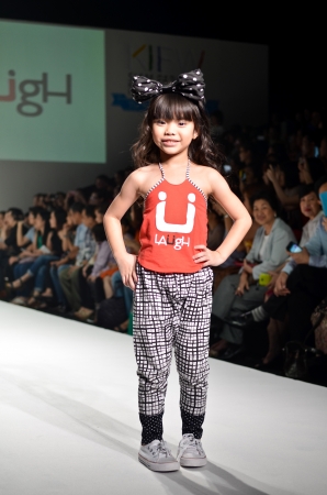 THAILAND, BANGKOK- OCT 2013 : A model walks the runway at the LAUGH New Collection 2013 at Kids Internation Fashion Week 2013 during 5-6 october, 2013 in Bangkok,Thailandのeditorial素材
