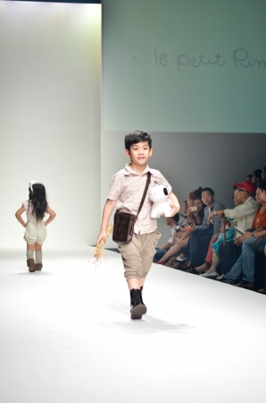 THAILAND, BANGKOK- OCT 2013 : A model walks the runway at the LE PETIT PUMM New Collection 2013 at Kids Internation Fashion Week 2013 during 5-6 october, 2013 in Bangkok,Thailandのeditorial素材