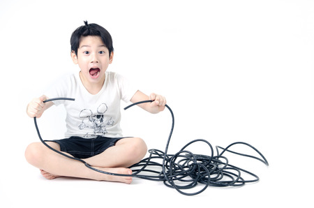 Portrait of Asian cute boy with electric wire cable on white background . の写真素材