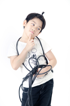 Portrait of Asian cute boy with electric wire cable on white background . の写真素材