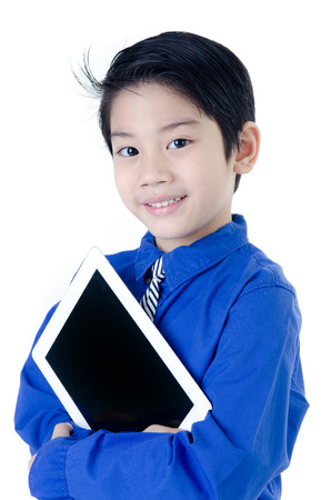 Happy Asian child with tablet computer on isolated の写真素材