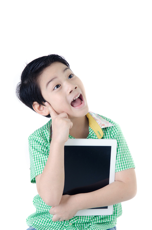 cute surprised asian boy with tablet computer on isolated backgroundの写真素材