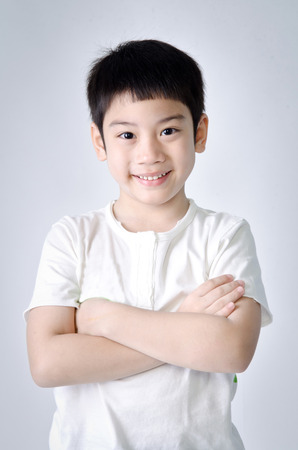 Portrait of smile asian cute boy on gray background . Studio fashion portrait.の写真素材