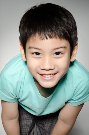 Portrade Of asian cute boy on gray background .の写真素材