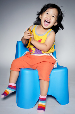 Portrait Of happy asian cute Girl on gray background .の写真素材