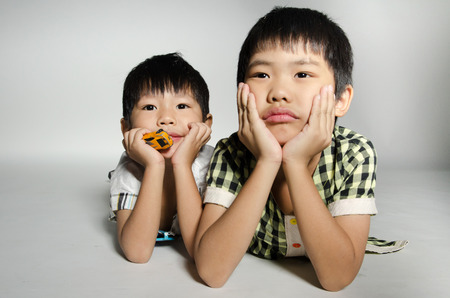 Portrait Of asian cute boys on gray background .の写真素材
