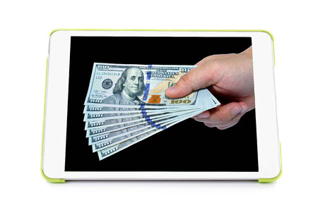 New One hundred dollars pile on hand on tablet computer screen on white background . の写真素材