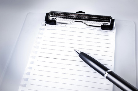 Lined notebook and pen on gray background . の写真素材