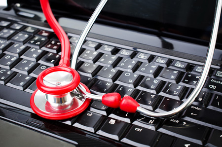 Red Stethoscope on labtop computer keyboard の写真素材