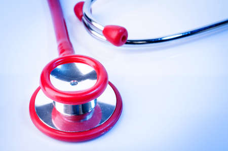 Close up of Red stethoscope on blue backgroundの写真素材
