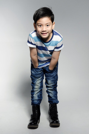 Portrait of little asian cute boy on gray background .の写真素材