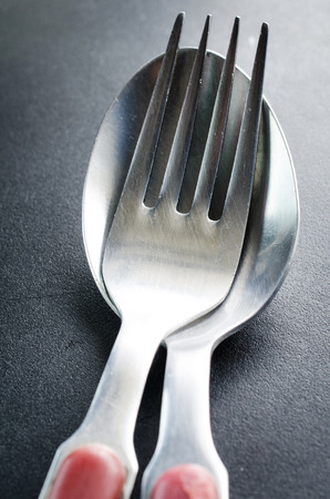 Used Old fork and spoon  on gray background . の写真素材