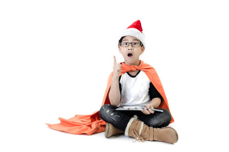 Little asian smile boy with santa hat acting think about that , isolated on white background.