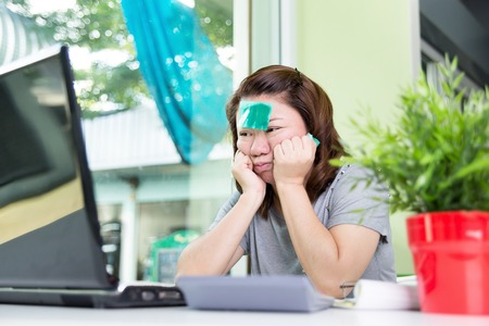 beautiful asian woman using laptop computer on work table , lose one's mind