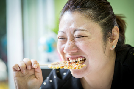 Asian woman eating dessert à¸à¸ banana roastの写真素材