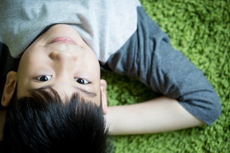 Happy Asian child playing in the park. on green background .の写真素材