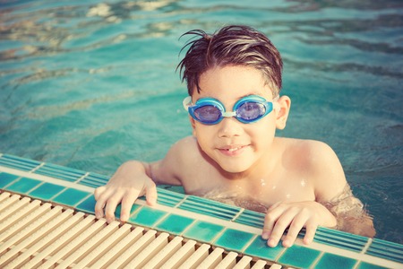 Portrait of happy asian little boy playing in the pool,Vintage style .の写真素材