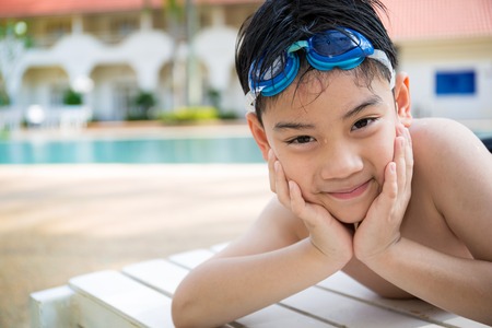 Portrait of happy asian little boy playing in the pool,Vintage style .の写真素材