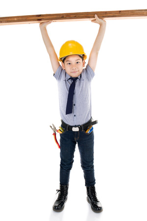 Young asian child construction engineer Holding equipment isolated on white backgroundの写真素材