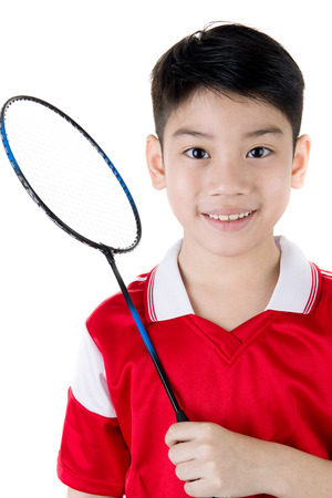Happy Asian boy in badminton action isolate on white backgroundの写真素材