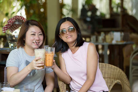Two Happy asian Female in coffeeshop Cafeの写真素材