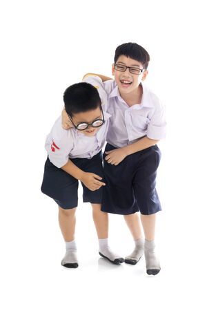 Full body shot of asian primary school students back from school, Isolate on white backgroundの写真素材